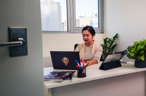 Woman working on laptop in Alfardan Centre